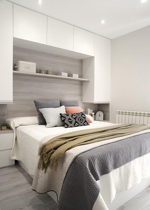Dormitorio con armarios a medida y cabecero panelado en madera