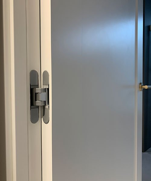 Bisagra oculta en puerta interior de diseño minimalista